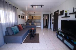 a living room with a couch and a table at Oceanus Summer House in Salamina