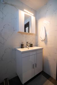 a bathroom with a white sink and a mirror at Oceanus Summer House in Salamina