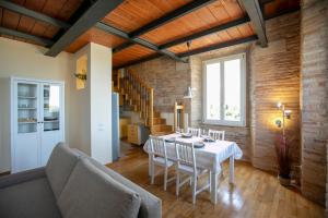 a dining room with a white table and chairs at NonSoloPanorama in Monte San Vito