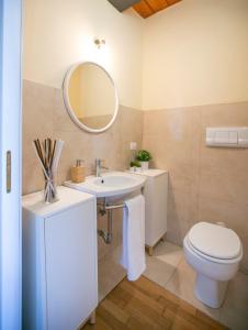 a bathroom with a sink and a toilet and a mirror at NonSoloPanorama in Monte San Vito