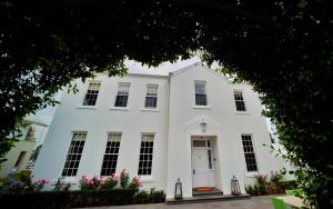 a white house with a white door and windows at Oscars Waterfront Boutique Hotel in Port Fairy