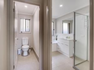 a bathroom with a toilet and a sink at Breeze in Toogoom in Toogoom +21 photos