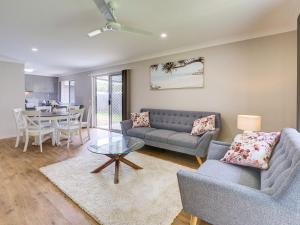 a living room with a couch and a table at Breeze in Toogoom in Toogoom