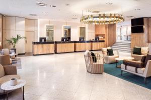 a lobby with a waiting room and a reception desk at Melia Avenida de America in Madrid