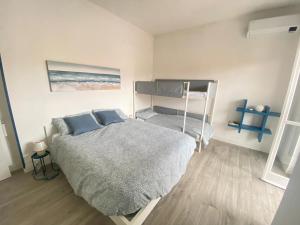 a bedroom with a bed and a bunk bed at Loano: Centro e Mare a portata di mano in Loano
