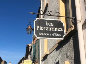 a sign hanging on the side of a building at Les Florentines in Carcassonne