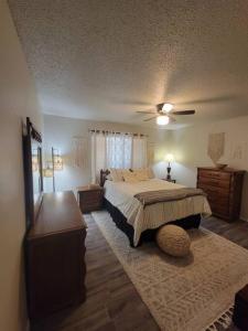 a bedroom with a bed and a ceiling fan at Desert Oasis With Hot Tub! in Las Cruces