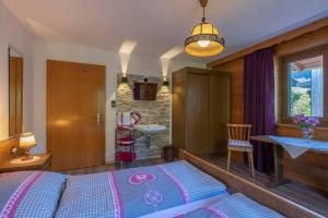 a bedroom with a bed and a bathroom with a sink at Ferienwohnung Michael Novablick in Gaschurn