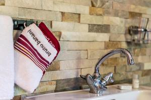 a towel hanging on a wall next to a sink at Ferienwohnung Michael Novablick in Gaschurn +11 photos