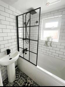 a white bathroom with a sink and a shower at Ayresome House in Middlesbrough