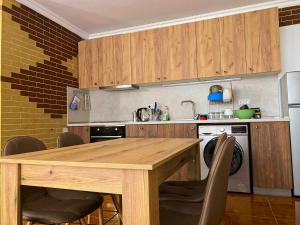 a kitchen with a wooden table with chairs and a sink at Casa Beach in Ravda