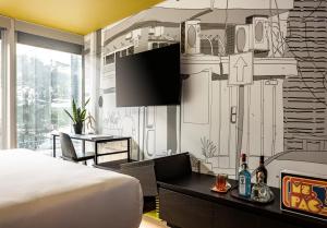 a bedroom with a bed and a wall mural at Play Midtown Hotel Tel Aviv in Tel Aviv