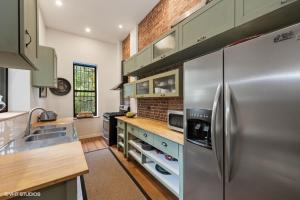 a kitchen with a stainless steel refrigerator at Home NYC in New York