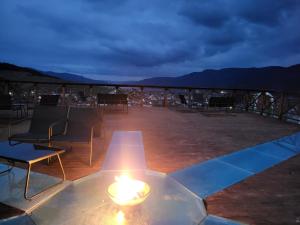 a candle on a table on a deck at night at Вилно селище PARADISE VIEW in Sarnitsa