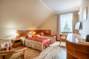 Postel nebo postele na pokoji v ubytování Lech Resort & Spa