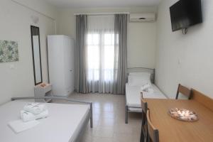 Postel nebo postele na pokoji v ubytování Kasimidis Apartments