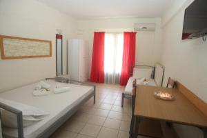 Postel nebo postele na pokoji v ubytování Kasimidis Apartments