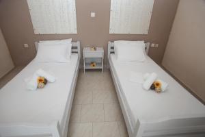 Postel nebo postele na pokoji v ubytování Kasimidis Apartments