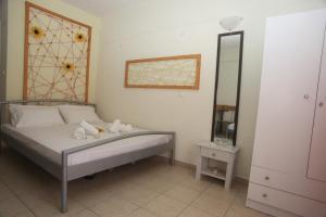 Postel nebo postele na pokoji v ubytování Kasimidis Apartments