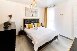 a bedroom with a large bed with yellow pillows at Color Studios in Nord10 - Pool & playground in Mamaia