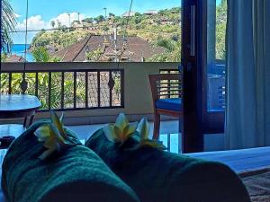 a room with a balcony with a view of the ocean at Sama Sama Amed in Amed