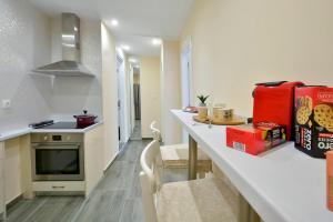 a kitchen with a counter and a red refrigerator at Saroko House in Corfu