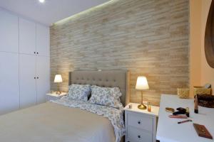 a bedroom with a bed with two night stands and two lamps at Saroko House in Corfu +20 photos