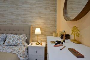a bedroom with a bed and a table with a lamp at Saroko House in Corfu