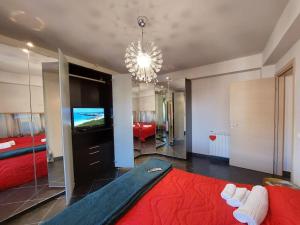 a bedroom with a large red bed and a television at Casa Cuore in Marsala