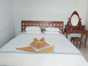 a bedroom with a bed with a towel on it at Sama Sama Amed in Amed