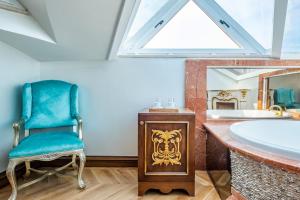 a bathroom with a blue chair and a tub at Magnificent Studio Flat in Uskudar in Istanbul