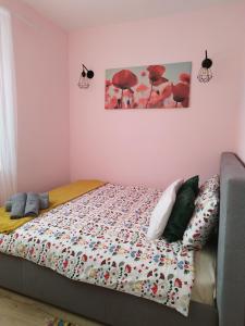 a bed with a comforter on it in a bedroom at Ropienka Ski in Ustrzyki Dolne