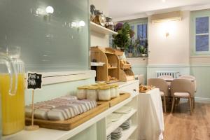 a room with a counter with plates and food on it at Hotel Infanta Isabel by Recordis Hotels in Segovia