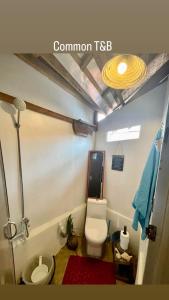 a bathroom with a toilet and a sink at Casita Francisco Siargao in General Luna