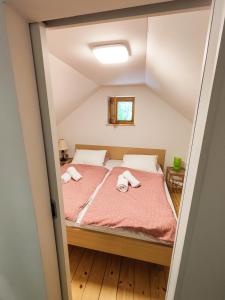 a bedroom with a bed with two towels on it at Silent Orchard in Naklo