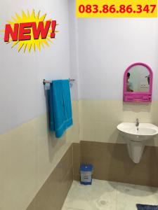 uma casa de banho com um lavatório, um WC e um espelho. em Nhà Nghỉ Năm Bé em Xuyên Mộc