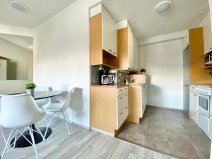 a kitchen and dining room with a table and chairs at City Home Finland Penthouse – SAUNA & Best Location in Tampere