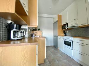 a kitchen with white cabinets and a counter top at City Home Finland Penthouse – SAUNA & Best Location in Tampere