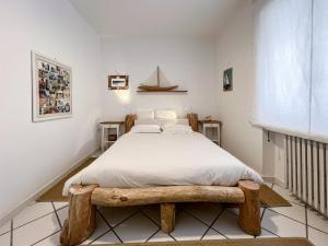 ポルトフェッラーイオにあるA casa di Enrico B&Bのベッドルーム1室(木製ベッドフレーム付きのベッド1台付)