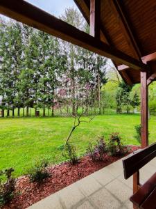 a view of a park with a tree with pink flowers at Silent Orchard in Naklo