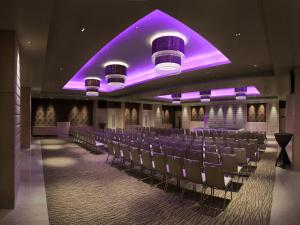 a conference room with chairs and purple lighting at The Raintree, Anna Salai in Chennai