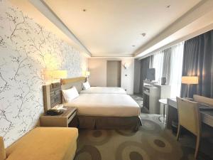 Postel nebo postele na pokoji v ubytování Fullon Hotel Kaohsiung