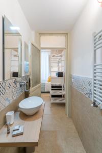 a bathroom with a bowl sink and a shower at Mama Tita Rooms and Breakfast in Palermo