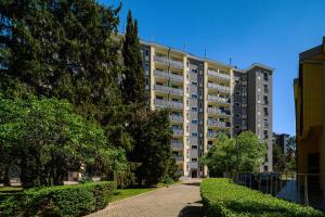een groot appartementencomplex met bomen ervoor bij Inganni Charme Apartment in Milaan