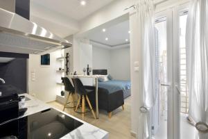 a bedroom with a bed and a desk in a room at Saroko Studio in Corfu