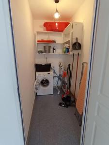 a laundry room with a washing machine and a washer at Chez Isa in Blâmont