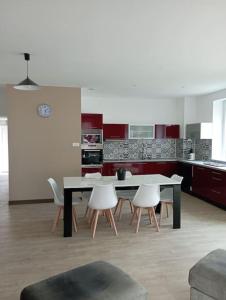 a kitchen with a table and chairs in a room at Chez Isa in Blâmont