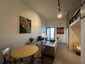 a living room with a table and a couch at KLSentral-Bangsar-MidValley-2-10pax-Netflix-Balcony-Super Fast Internet in Kuala Lumpur