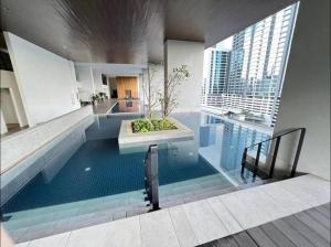 a large swimming pool in a building with a building at KLSentral-Bangsar-MidValley-2-10pax-Netflix-Balcony-Super Fast Internet in Kuala Lumpur