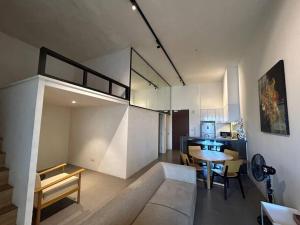 a living room with a couch and a dining room at KLSentral-Bangsar-MidValley-2-10pax-Netflix-Balcony-Super Fast Internet in Kuala Lumpur